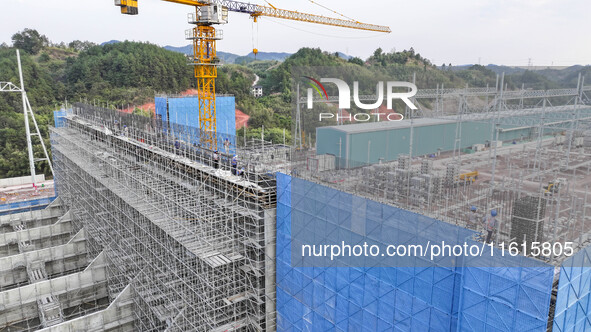 Construction workers work at the construction site of the 800 kV Yubei converter station in Chongqing, China, on September 28, 2024. 