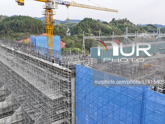 Construction workers work at the construction site of the 800 kV Yubei converter station in Chongqing, China, on September 28, 2024. (