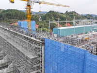 Construction workers work at the construction site of the 800 kV Yubei converter station in Chongqing, China, on September 28, 2024. (