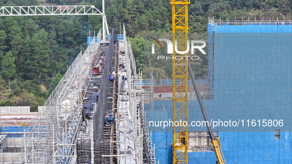 Construction workers work at the construction site of the 800 kV Yubei converter station in Chongqing, China, on September 28, 2024. 