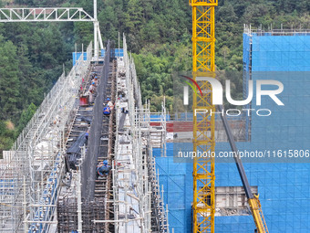 Construction workers work at the construction site of the 800 kV Yubei converter station in Chongqing, China, on September 28, 2024. (