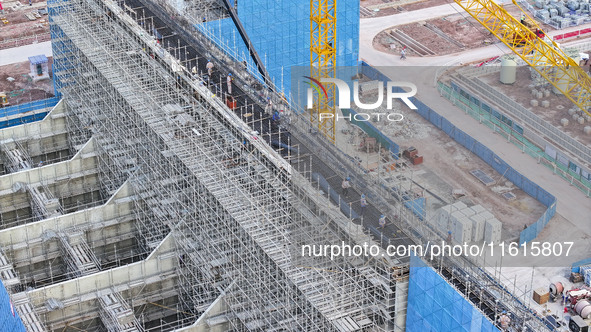 Construction workers work at the construction site of the 800 kV Yubei converter station in Chongqing, China, on September 28, 2024. 