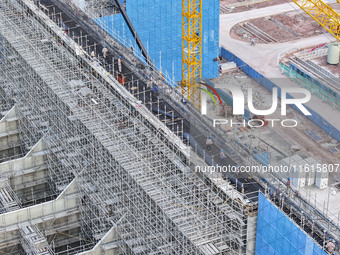 Construction workers work at the construction site of the 800 kV Yubei converter station in Chongqing, China, on September 28, 2024. (