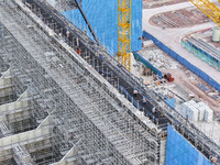 Construction workers work at the construction site of the 800 kV Yubei converter station in Chongqing, China, on September 28, 2024. (