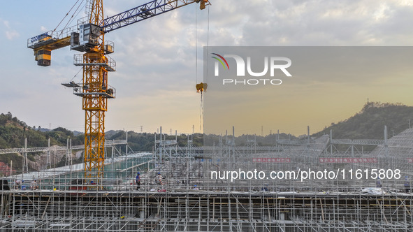 Construction workers work at the construction site of the 800 kV Yubei converter station in Chongqing, China, on September 28, 2024. 