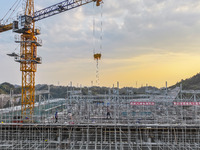 Construction workers work at the construction site of the 800 kV Yubei converter station in Chongqing, China, on September 28, 2024. (