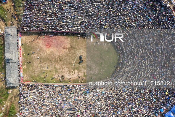 People watch a bullfight at the Songxue bullfight pond in Congjiang county, Southwest China's Guizhou province, on September 28, 2024. 