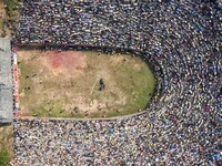 People watch a bullfight at the Songxue bullfight pond in Congjiang county, Southwest China's Guizhou province, on September 28, 2024. (