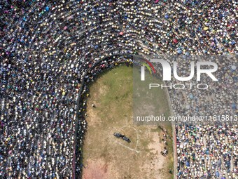 People watch a bullfight at the Songxue bullfight pond in Congjiang county, Southwest China's Guizhou province, on September 28, 2024. (