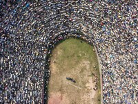 People watch a bullfight at the Songxue bullfight pond in Congjiang county, Southwest China's Guizhou province, on September 28, 2024. (