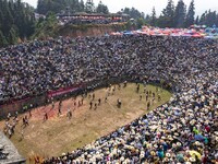 People watch a bullfight at the Songxue bullfight pond in Congjiang county, Southwest China's Guizhou province, on September 28, 2024. (