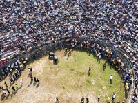 People watch a bullfight at the Songxue bullfight pond in Congjiang county, Southwest China's Guizhou province, on September 28, 2024. (