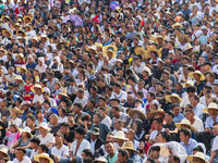 People watch a bullfight at the Songxue bullfight pond in Congjiang county, Southwest China's Guizhou province, on September 28, 2024. (