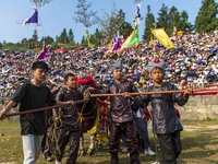 People watch a bullfight at the Songxue bullfight pond in Congjiang county, Southwest China's Guizhou province, on September 28, 2024. (