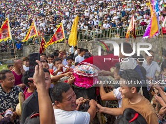 People watch a bullfight at the Songxue bullfight pond in Congjiang county, Southwest China's Guizhou province, on September 28, 2024. (