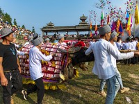 People watch a bullfight at the Songxue bullfight pond in Congjiang county, Southwest China's Guizhou province, on September 28, 2024. (