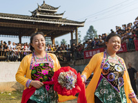 People watch a bullfight at the Songxue bullfight pond in Congjiang county, Southwest China's Guizhou province, on September 28, 2024. (