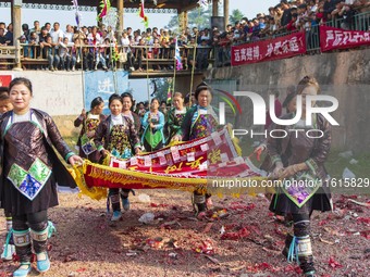 People watch a bullfight at the Songxue bullfight pond in Congjiang county, Southwest China's Guizhou province, on September 28, 2024. (