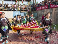 People watch a bullfight at the Songxue bullfight pond in Congjiang county, Southwest China's Guizhou province, on September 28, 2024. (