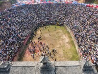 People watch a bullfight at the Songxue bullfight pond in Congjiang county, Southwest China's Guizhou province, on September 28, 2024. (