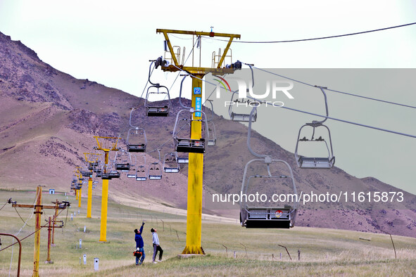 Staff members check the safety operation of the gondola at the Qilian Mountain ski resort in Zhangye, China, on September 28, 2024. 