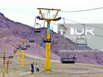 Staff members check the safety operation of the gondola at the Qilian Mountain ski resort in Zhangye, China, on September 28, 2024. (