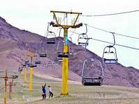 Staff members check the safety operation of the gondola at the Qilian Mountain ski resort in Zhangye, China, on September 28, 2024. (