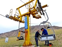 Staff members check the safety operation of the gondola at the Qilian Mountain ski resort in Zhangye, China, on September 28, 2024. (