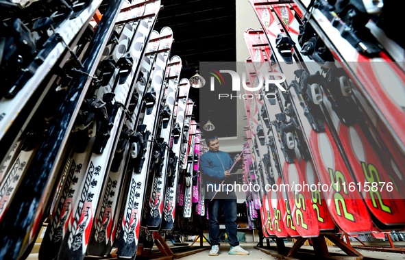 Staff members repair skis at the Qilian Mountain ski resort in Zhangye, China, on September 28, 2024. 