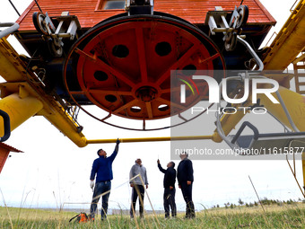 Staff members check the safety operation of the gondola at the Qilian Mountain ski resort in Zhangye, China, on September 28, 2024. (