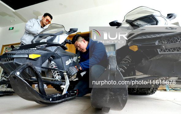 A snowmobile is repaired at the Qilian Mountain ski resort in Zhangye, China, on September 28, 2024. 