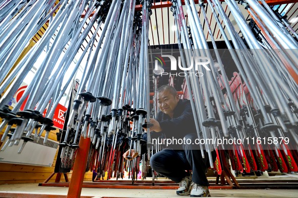 Staff members repair ski poles at the Qilian Mountain ski resort in Zhangye, China, on September 28, 2024. 