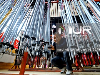 Staff members repair ski poles at the Qilian Mountain ski resort in Zhangye, China, on September 28, 2024. (