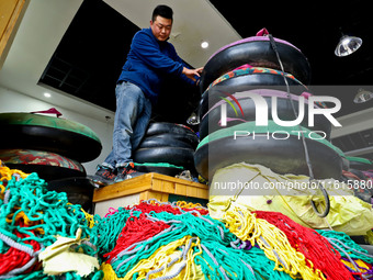 A staff member repairs a ski ring at the Qilian Mountain ski resort in Zhangye, China, on September 28, 2024. (