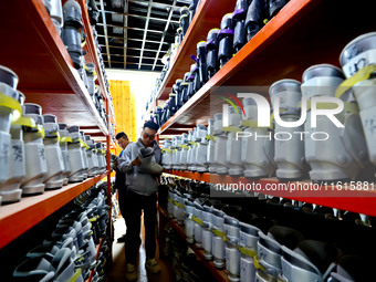 Staff members repair ski boots at the Qilian Mountain ski resort in Zhangye, China, on September 28, 2024. (