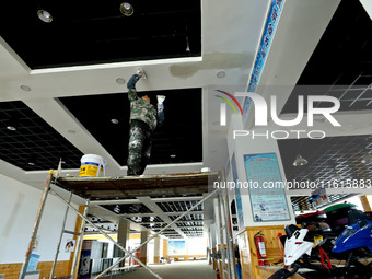 Staff work on the interior renovation of the visitor center at the Qilian Mountain ski resort in Zhangye, China, on September 28, 2024. (