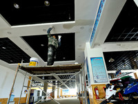 Staff work on the interior renovation of the visitor center at the Qilian Mountain ski resort in Zhangye, China, on September 28, 2024. (