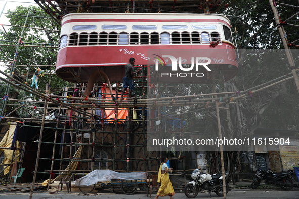 Artisans clean a model of a tram on a temporary platform ahead of the Durga Puja festival in Kolkata, India, on September 28, 2024. The annu...