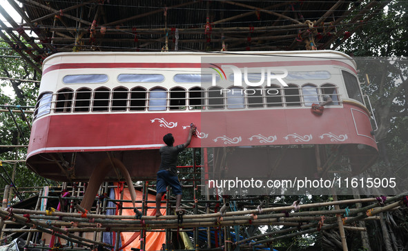 Artisans clean a model of a tram on a temporary platform ahead of the Durga Puja festival in Kolkata, India, on September 28, 2024. The annu...