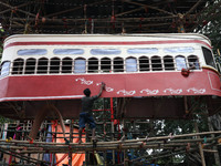 Artisans clean a model of a tram on a temporary platform ahead of the Durga Puja festival in Kolkata, India, on September 28, 2024. The annu...