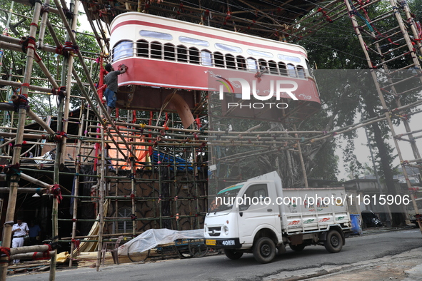 Artisans clean a model of a tram on a temporary platform ahead of the Durga Puja festival in Kolkata, India, on September 28, 2024. The annu...