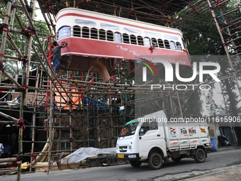 Artisans clean a model of a tram on a temporary platform ahead of the Durga Puja festival in Kolkata, India, on September 28, 2024. The annu...