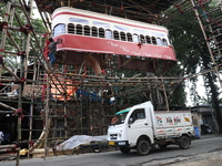 Artisans clean a model of a tram on a temporary platform ahead of the Durga Puja festival in Kolkata, India, on September 28, 2024. The annu...