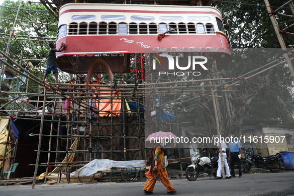 Artisans clean a model of a tram on a temporary platform ahead of the Durga Puja festival in Kolkata, India, on September 28, 2024. The annu...