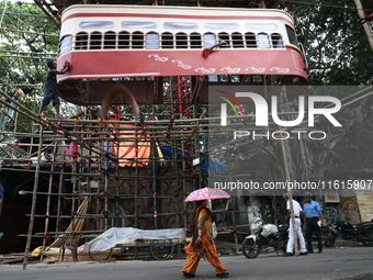 Artisans clean a model of a tram on a temporary platform ahead of the Durga Puja festival in Kolkata, India, on September 28, 2024. The annu...