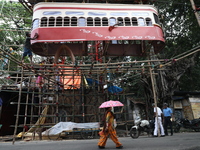 Artisans clean a model of a tram on a temporary platform ahead of the Durga Puja festival in Kolkata, India, on September 28, 2024. The annu...