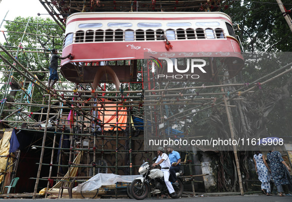 Artisans clean a model of a tram on a temporary platform ahead of the Durga Puja festival in Kolkata, India, on September 28, 2024. The annu...