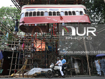 Artisans clean a model of a tram on a temporary platform ahead of the Durga Puja festival in Kolkata, India, on September 28, 2024. The annu...