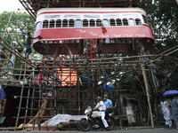 Artisans clean a model of a tram on a temporary platform ahead of the Durga Puja festival in Kolkata, India, on September 28, 2024. The annu...