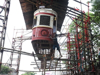 An artisan cleans a model of a tram on a temporary platform ahead of the Durga Puja festival in Kolkata, India, on September 28, 2024. The a...